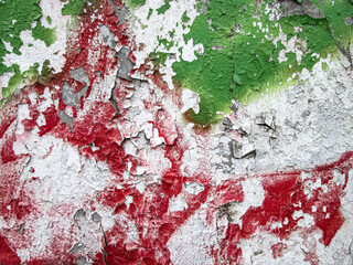 Red and green strokes on peeling old paint. White decay texture.