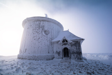 old chapel on peak of Sniezka mountain in Karkonosze in Poland and Czech republic border during winter