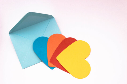 love message background for gay love. Colorful papers and envelope concept photo in heart shape, top view. copy space for your text.