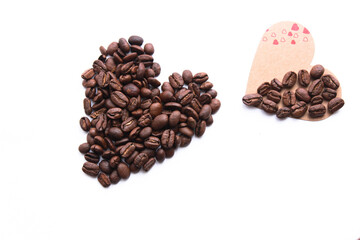 Heart shape made from coffee beans, love and coffee themed concept background photo isolated on white background. Top view, copy space for your text.