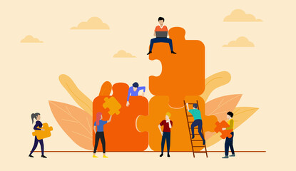 Teamwork concept. People working with giant jigsaw pieces on orange sky background