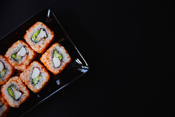 Set of Japanese sushi roll on dark background © Mariia Razdorova