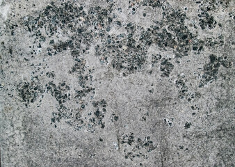 Concrete wall with stone roughness. Shabby surface with grain.