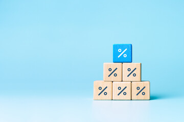 Wooden blocks with percentage sign, interest rate decline, investment reduce or Sales discount...