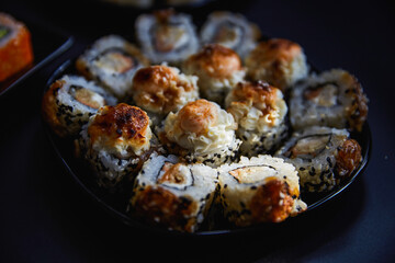 Fresh sushi rolls set on gark background