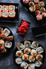 Fresh sushi rolls set on gark background