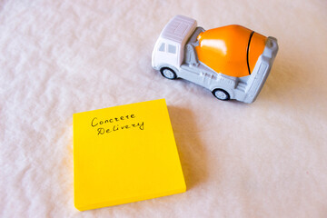 layout of concrete truck mixer on rough white-grey background. Free copy space. Delivery of ready...