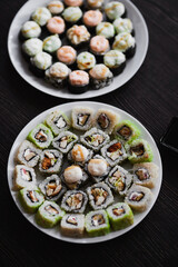 Fresh sushi rolls set on gark background