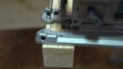 Close-up of a piece of wood cutting with a jigsaw. Home repair yourself