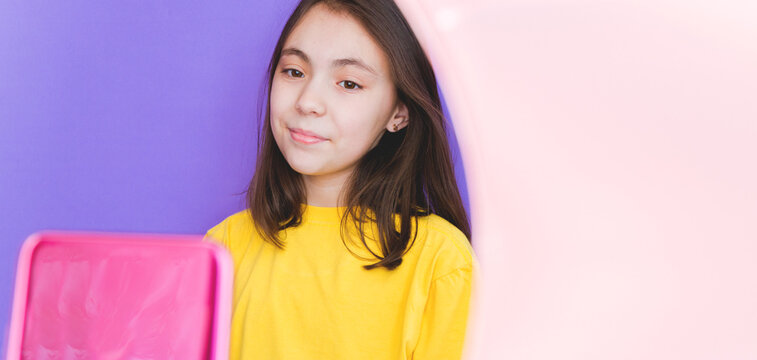 A girl blogger talks to subscribers, conducts a live broadcast, looks at the smartphone screen. Make a video call to friends and parents. Social networks