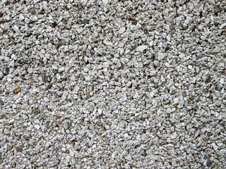 Small crushed stone. Rough texture, jagged and uneven.