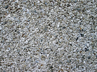 Gray stone background. Detailed small stones on the wall.