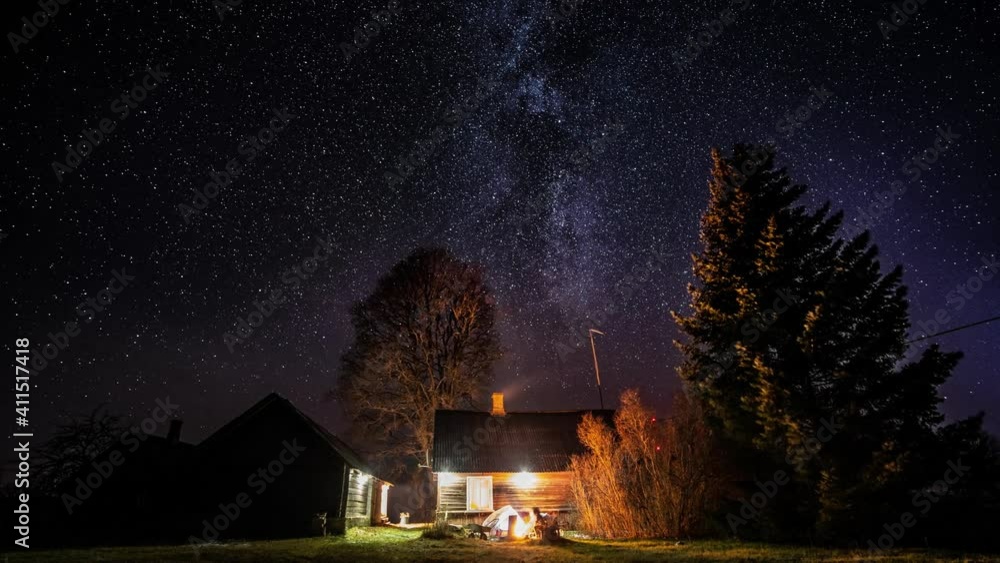 Wall mural milky way timelapse with stars in clear summer night. old barn house. country side. timelapse footag