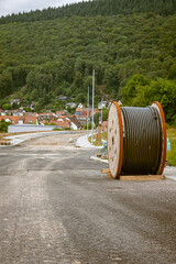 Cable drum for power cable during road construction in a new development area in Germany