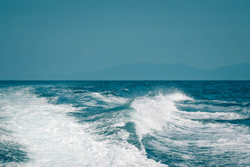 Vintage and retro toning of tropical beach with blue sky and clear sea which including of a wooden boat in sunrise time with vintage retro tone. Vacation time as concept.
