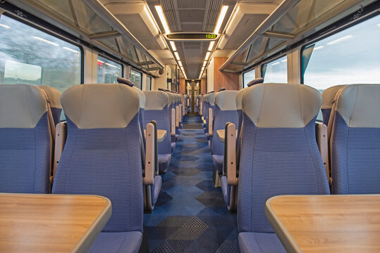 Interior of an empty commuter train carriage with seats