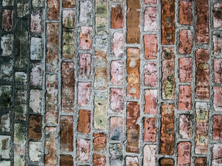 Texture of multicolored vertical bricks, brown masonry building stone.