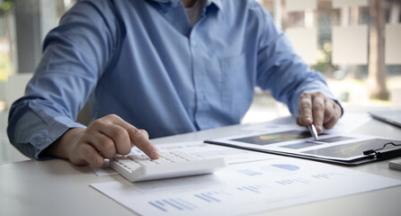 Financial businessman calculating corporate income tax data And analyzing charts of financial stocks that are in good condition with growth and progress, Investment in finance and accounting