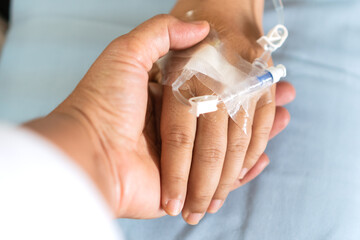 Encouragement of patient comforting Recovering moment in Hospital. Hopeful care love emotional concept, Couple women hold hands lover while Sick Patients saline Iv drip,intravenous needle,feeling love