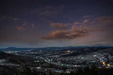 Fototapeta premium Clouds in the evening over a village in the carpathians