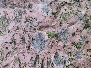 Abstract pale pink background with damages. Destroyed old paint on battered concrete.