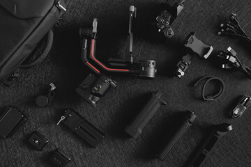 top view of work space photographer with digital camera, Gimbal Stabilizers and camera accessory