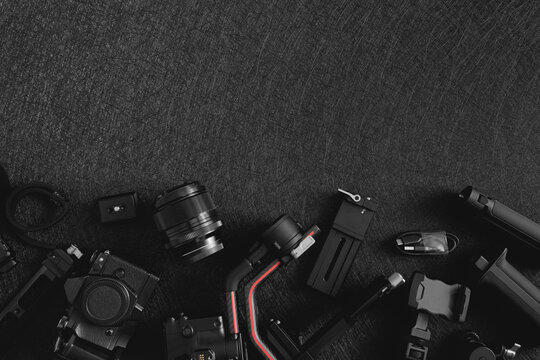 top view of work space photographer with digital camera, Gimbal Stabilizers and camera accessory