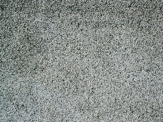 Gray texture of granular stone pavement. Concrete surface with a rough solid color pattern. Construction background for design. Abstract Stock Photo.