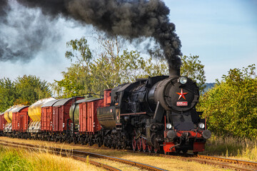 historic steam locomotive with freight train