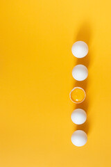 Chicken white eggs on a yellow background.