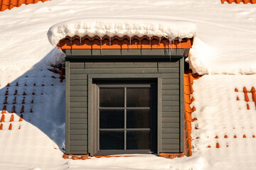 Dormer on a roof under a layer of snow