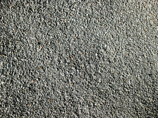 Granular surface of fine stone coating. Texture with frozen fine particles. Natural building material.