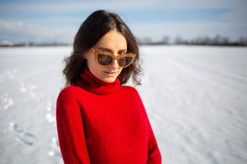 Happy woman traveler on the snowy field