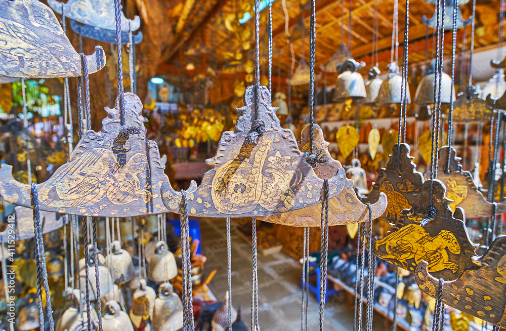 Poster Lions and serpents on Burmese gongs, Htilominlo Temple market, Bagan, Myanmar