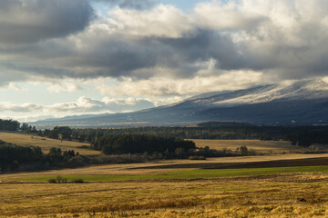 Dramatic clouds over valley under High Tatras mountains, Slovakia. Sunny winter day.