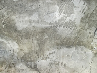 Stains on the smeared concrete surface. Stock gray background with roughness and grain. Abstraction with a frozen stone coating.