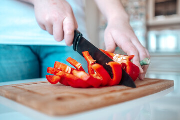 Pepper is cut with a knife