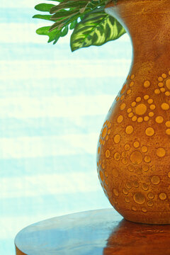 Abstract, round and curve patterns on surface of vase, light blue background 
