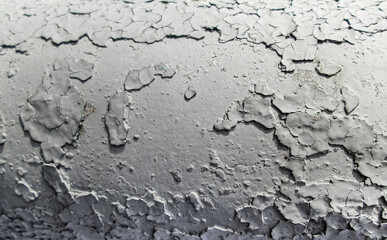 Large chunks white paint. Falling off old surface. The effect of abandonment and destruction.