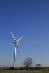 wind turbine clear blue sky and jet trail
