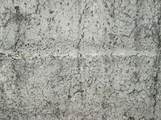 Light concrete surface with streaks and roughness. Plain cement texture with a pattern.
