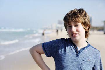 Cute 13 year old teenager with autism posing at the sea - 411538053