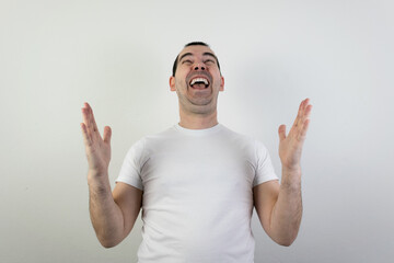 happy excited young man stand white background laugh hands up crazy look angry