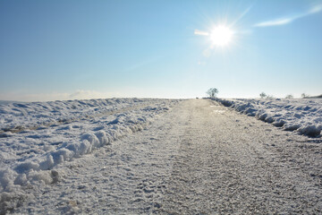 A snow-covered road in the country