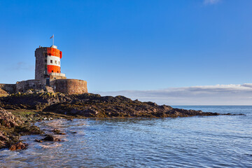 Image of Archirondel Bay with the Napoleonic Jersey Tower early on a sunny day. Jersey, Channel Islands