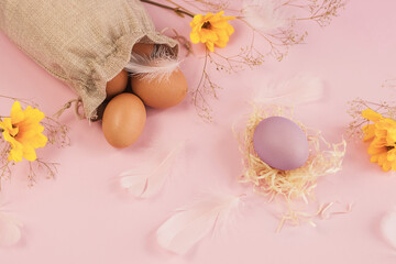 Easter eggs and spring flowers on a colorful background. Happy Easter. Holiday concept. Copy space.
