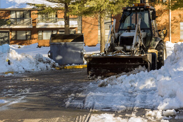 Fototapeta na wymiar Municipal equipment removing snow outdoors cleaning roads in winter