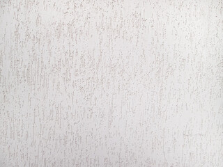 Texture of a white wall with a grungy pattern. Scratches and gouges in the cement pavement.