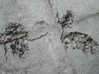 Potholes in the concrete wall. Waste element with a destroyed building. A hole in the hard surface of the building.