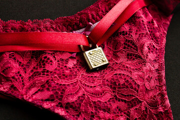 Red female panties with padlock, symbol of marital fidelity